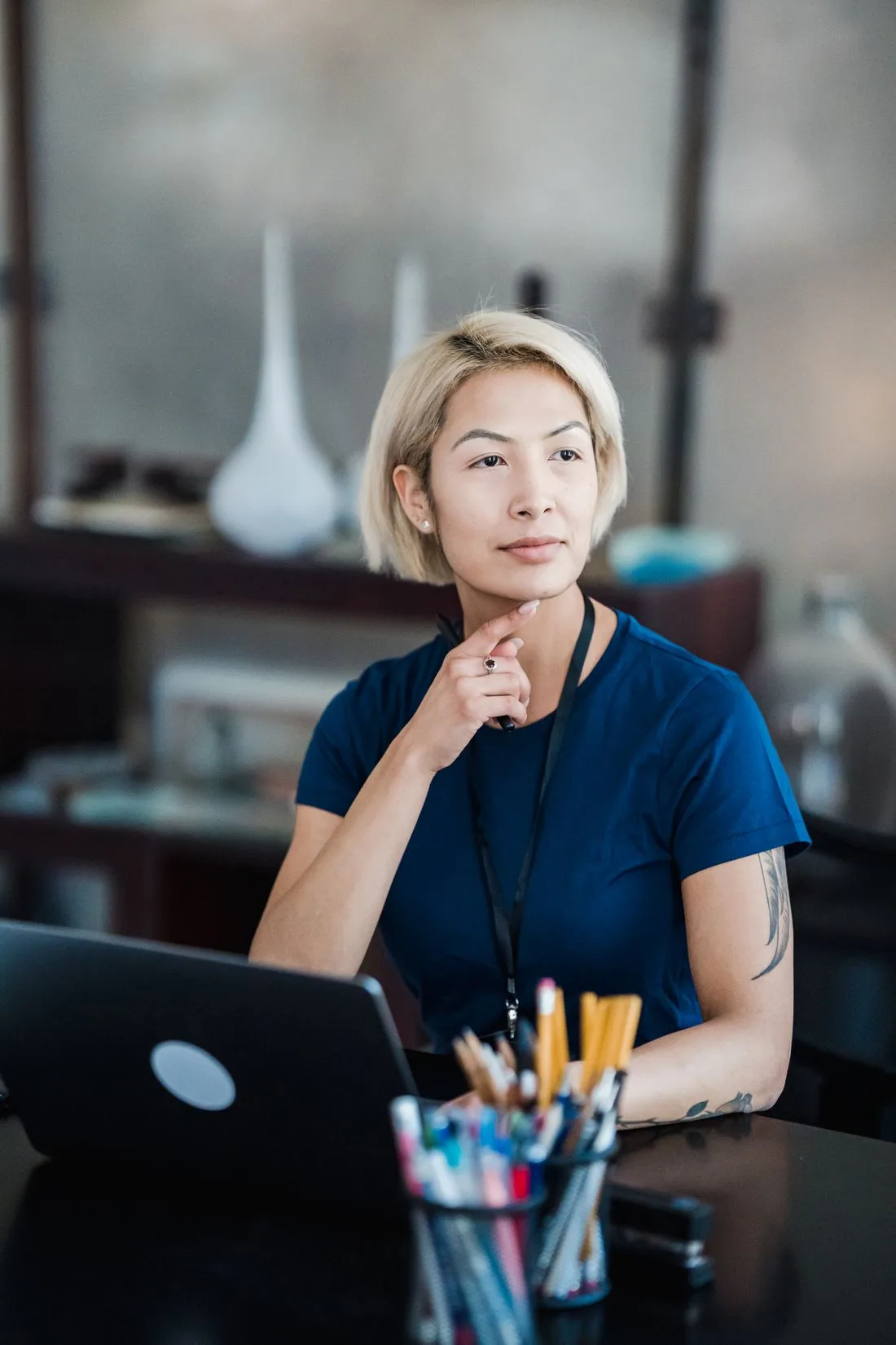 A professional taking a moment to think at her desk